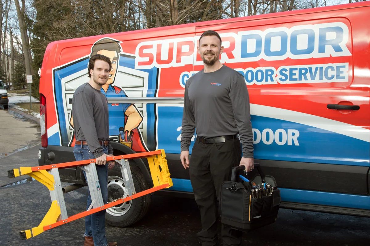 technician giving new garage door estimate to happy customer